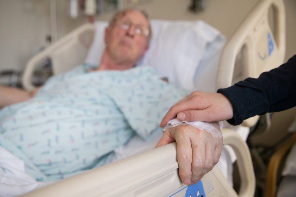 holding hands with elderly patient at hospital IVC Filters