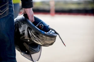 A biker is holding their helmet