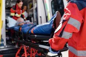 An accident victim is loaded into an ambulance by first responders.