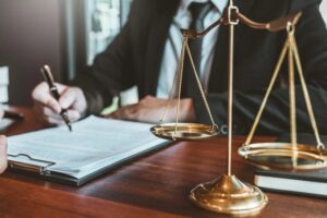 A lawyer sitting at their desk going over legal documents.